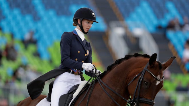 United States' Laura Graves, riding Verdades, competes in the equestrian dressage competition at the 2016 Summer Olympics in Rio de Janeiro, Brazil, Friday, Aug. 12, 2016.