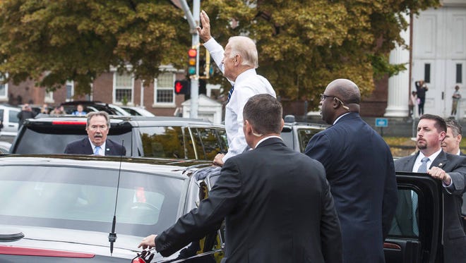 Vice -President Joe Biden waves to the crowd outside the Penny Cluse Cafe in Burlington before participating in a Cancer Moonshot Roundtable at the University of Vermont on Friday, October 21, 2016.