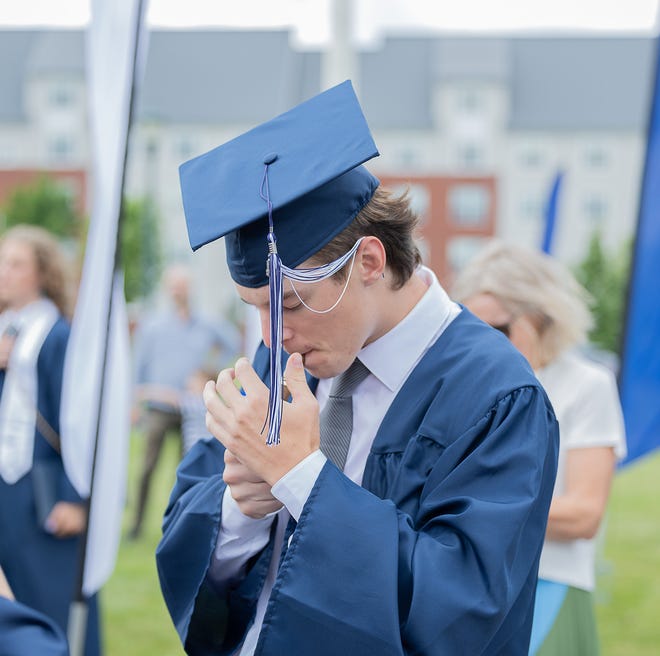 Rowen Charles Clarke lights his cigar to celebrate his graduation from Burlington High School after commencement ceremonies on Thursday, June 13, 2024, at University of Vermont Patrick Gymnasium in Burlington.