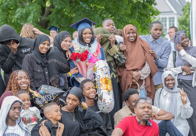 Fardowsa Aden stands with her family after graduation ceremonies for Burlington High School on Thursday, June 13, 2024, at University of Vermont Patrick Gymnasium in Burlington.