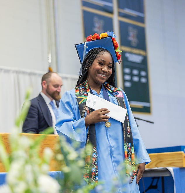 Maya Tsehai Akilah Jones receives the South Burlington Tim Wile Reach Up Scholarship during graduation ceremonies for South Burlington High School on Friday, June 14, 2024, at University of Vermont's Patrick Gymnasium in Burlington.