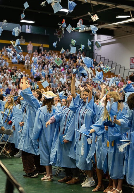 Students throw their hats in the air to celebrate during graduation ceremonies for South Burlington High School on Friday, June 14, 2024, at University of Vermont's Patrick Gymnasium in Burlington.