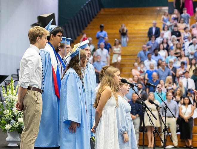 The South Burlington High School chamber singers perform the National Anthem during graduation ceremonies for South Burlington High School on Friday, June 14, 2024, at University of Vermont's Patrick Gymnasium in Burlington.