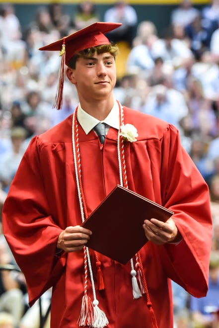 Jack St. Peter, a graduate of the class of 2024, receives his diploma at the 60th Commencement Exercise of the Champlain Valley Union High School on Friday, June 14, 2024, at UVM's Patrick Gym in Burlington.