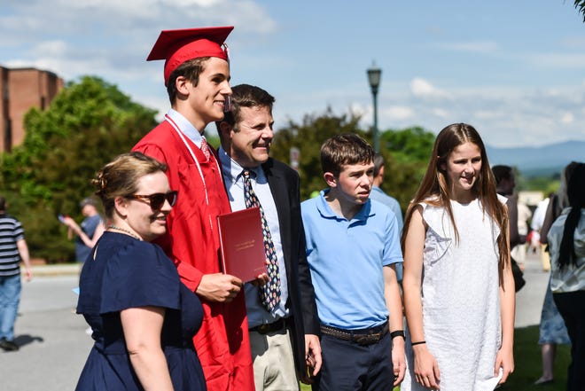 Friends and family take photos with their new graduates at the 60th Commencement Exercise of the Champlain Valley Union High School on Friday, June 14, 2024, at UVM's Patrick Gym in Burlington.