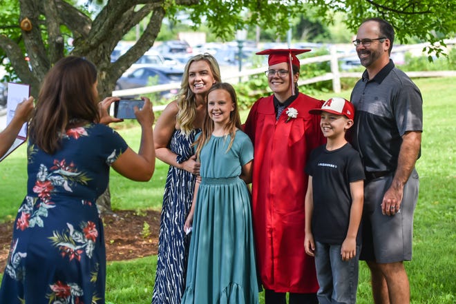 Friends and family take photos with their new graduates at the 60th Commencement Exercise of the Champlain Valley Union High School on Friday, June 14, 2024, at UVM's Patrick Gym in Burlington.