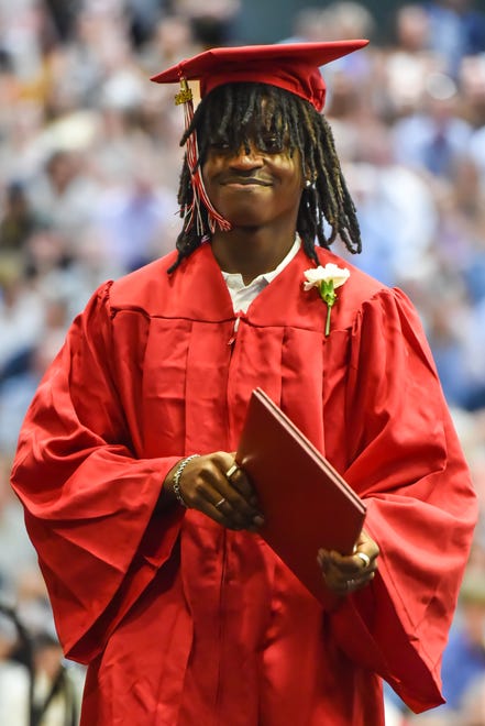 Trevor Asiimwe, a graduate of the class of 2024, receives his diploma at the 60th Commencement Exercise of the Champlain Valley Union High School on Friday, June 14, 2024, at UVM's Patrick Gym in Burlington.