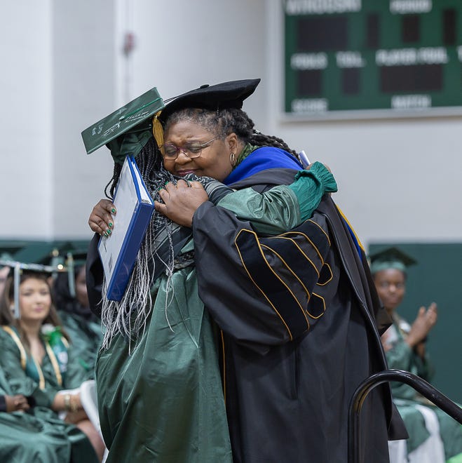 Keynote speaker Jolivette Anderson-Douoning hugs her daughter, Nadja Douoning, during graduation ceremonies for Winooski High School on Saturday, June 15, 2024, at Winooski High School in Winooski.