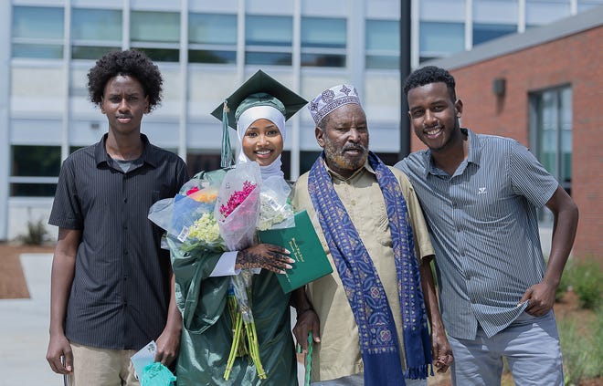 Saruro Mohamed Ali stands with her family after graduation ceremonies for Winooski High School on Saturday, June 15, 2024, at Winooski High School in Winooski.