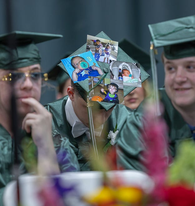 A student displays a decorative mortarboard at graduation ceremonies for Winooski High School on Saturday, June 15, 2024, at Winooski High School in Winooski.