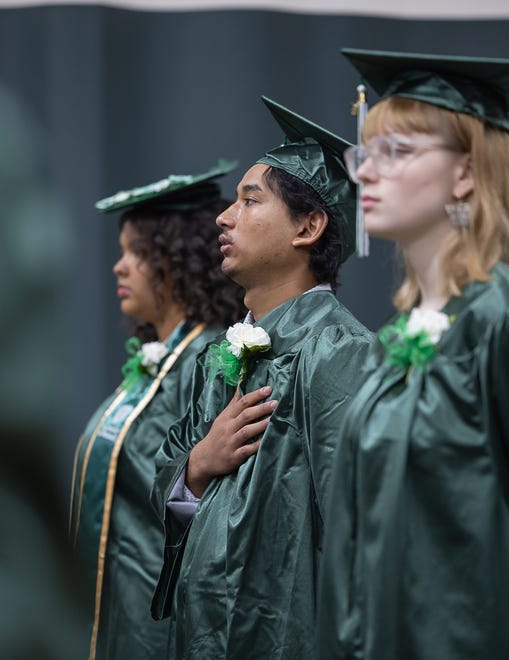 Students stand for the national anthem during graduation ceremonies for Winooski High School on Saturday, June 15, 2024, at Winooski High School in Winooski.