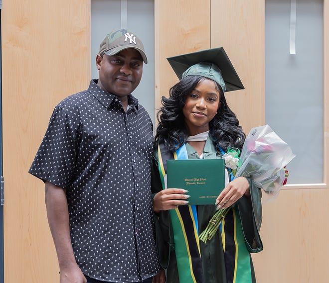 Nadine Ikizakubuntu stands with her father after graduation ceremonies for Winooski High School on Saturday, June 15, 2024, at Winooski High School in Winooski.