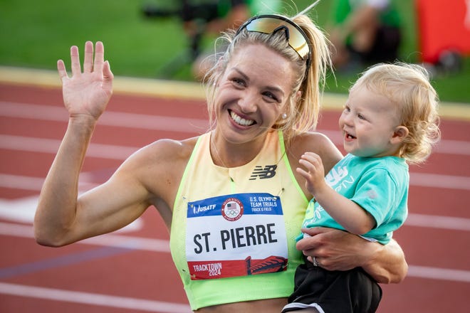 Elle St. Pierre holds her 15-month-old son Ivan after winning the women’s 5,000 meters during day four of the U.S. Olympic Track & Field Trials Monday, June 24, 2024, at Hayward Field in Eugene, Ore.