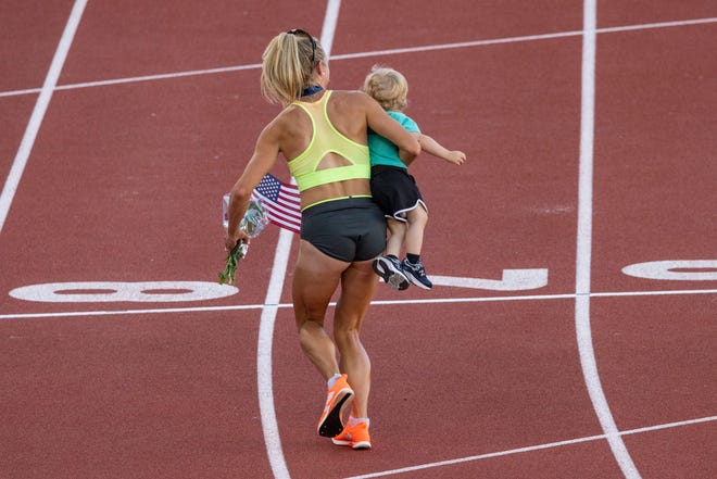 Women's 5,000 meters champion Elle St. Pierre leaves the track carrying her 15-month-old son Ivan during day four of the U.S. Olympic Track and Field Trials at Hayward Field in Eugene, Ore., on Monday, June 24, 2024.