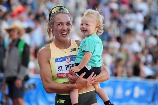 Elle St. Pierre holds her son after winning the women's 5,000m in a meet record 14:40.34 during the US Olympic Team Trials at Hayward Field.