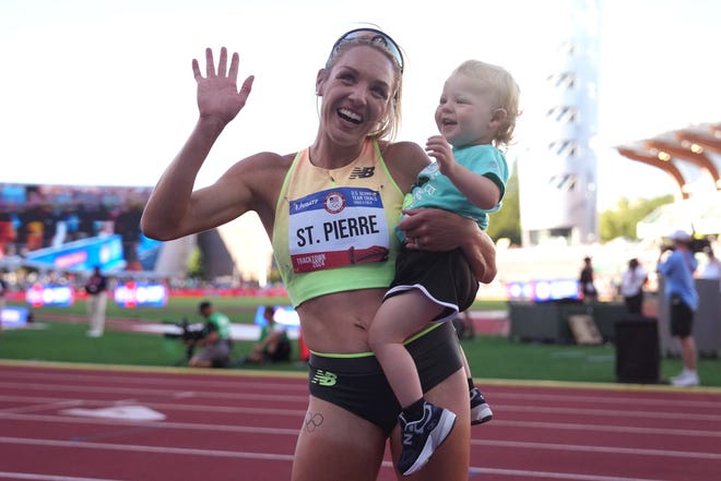 Elle St. Pierre holds her son after winning the women's 5,000m in a meet record 14:40.34 during the US Olympic Team Trials at Hayward Field.