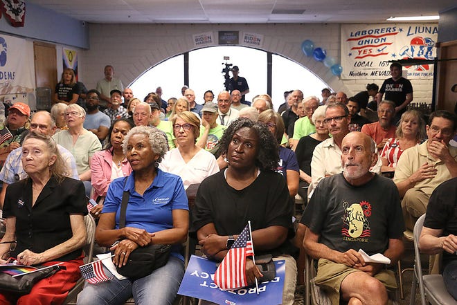 People gather to watch the debate between President Biden and ex-President Trump at the Washoe County Democratic Party headquarters in Reno on June 27, 2024.