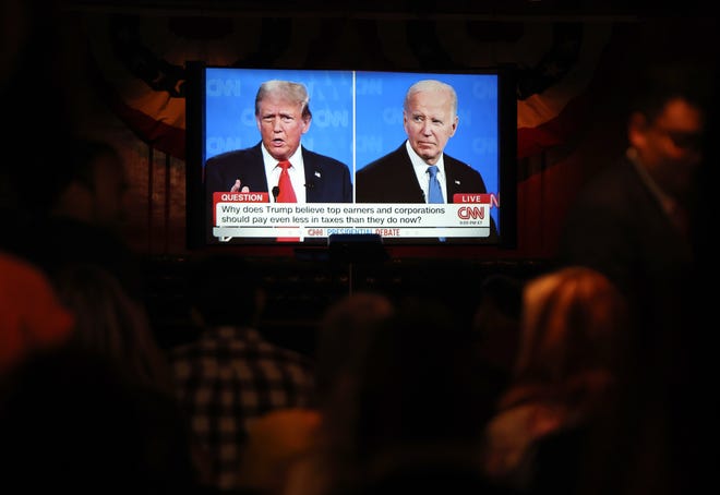 People watch President Joe Biden debate former President Donald Trump on June 27, 2024, in Los Angeles.