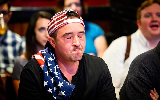 A patron reacts during a watch party for the first presidential debate of the 2024 presidential elections between President Joe Biden and former President and Republican presidential candidate Donald Trump at a pub in San Francisco, California, on June 27, 2024. The presidential debate is taking place in Atlanta, Georgia.