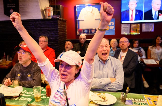 Patrons react during a watch party for the first presidential debate of the 2024 presidential elections between President Joe Biden and former President and Republican presidential candidate Donald Trump at a pub in San Francisco, California, on June 27, 2024. The presidential debate is taking place in Atlanta, Georgia.