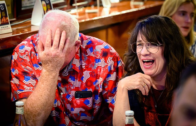 Patrons react during a watch party for the first presidential debate of the 2024 presidential elections between US President Joe Biden and former US President and Republican presidential candidate Donald Trump at a pub in San Francisco, California, on June 27, 2024. The presidential debate is taking place in Atlanta, Georgia.