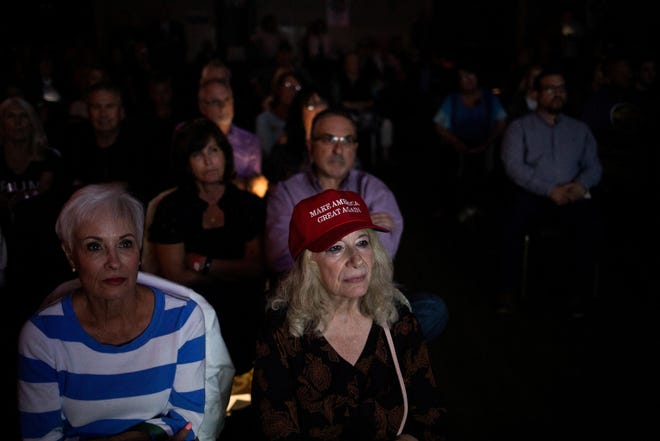 People watch the first presidential debate between President Joe Biden and former President and Republican presidential candidate Donald Trump during a watch party hosted by the Michigan Conservative Coalition in Novi, Michigan on June 27, 2024.