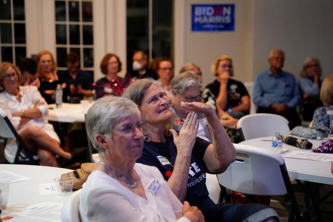 People react as they watch the debate as The New Hanover County Democratic party hosts a watch party as President Joe Biden and former President Donald Trump face off in the first presidential debate of the 2024 election, in Wilmington, North Carolina on June 27, 2024.