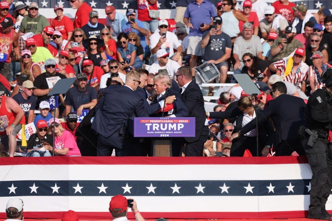 Once the Secret Service team got the all-clear, they brought Trump to his feet again.