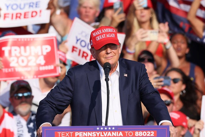 Republican presidential candidate and former President Donald Trump speaks at a campaign rally before shots were fired and he was escorted off the stage in Butler, Pennsylvania, on July 13, 2024.