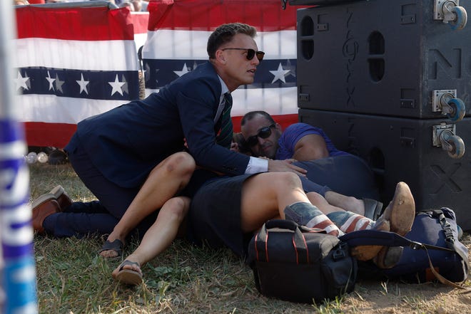 Members of the crowd are seen taking cover at the rally on July 13, 2024 in Butler, Pennsylvania.