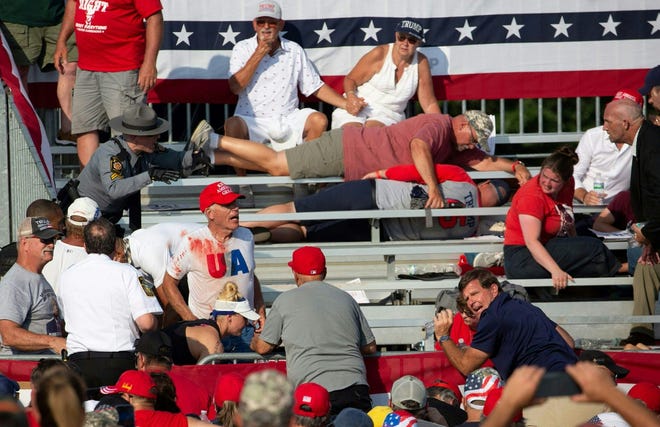 Trump supporters are seen covered with blood in the stands after guns were fired at Republican candidate Donald Trump at a campaign event at Butler Farm Show Inc. in Butler, Pennsylvania, July 13, 2024.