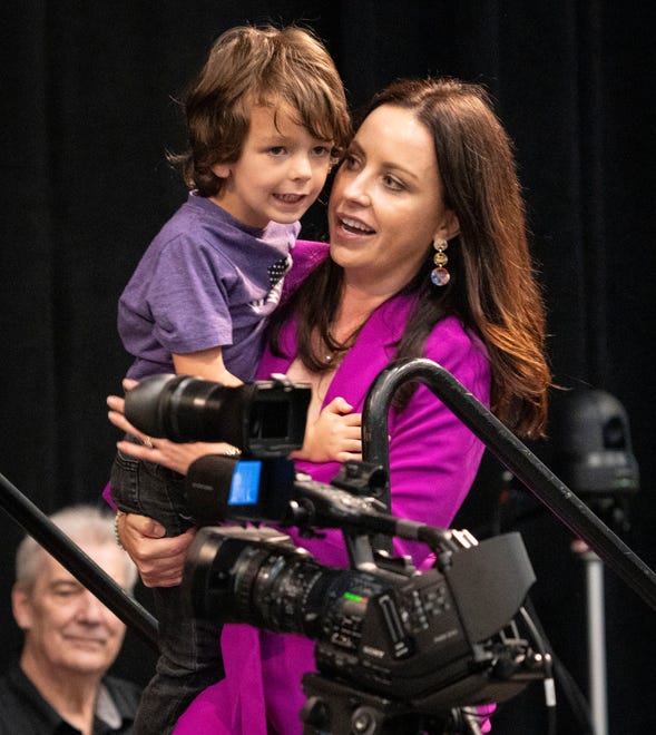 Destiny Wells takes her son to the stage after giving her acceptance speech for earning the Democratic nomination for attorney general Saturday, July 13, 2024, during the Indiana Democratic State Convention in Indianapolis.