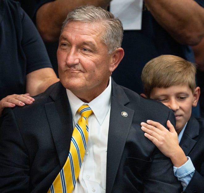 Berley Goodin, 11, holds his dad, Terry Goodin, as the results for the lieutenant governor nominee are read Saturday, July 13, 2024, during the Indiana Democratic State Convention in Indianapolis.