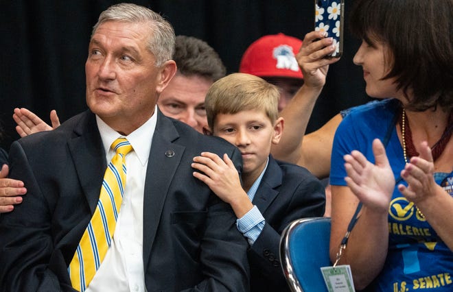 Berley Goodin, 11, holds his dad, Terry Goodin, as the results for the lieutenant governor nominee are read Saturday, July 13, 2024, during the Indiana Democratic State Convention in Indianapolis.