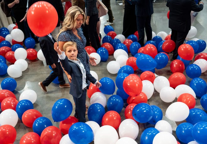 Brown Goodin, 8, tries to hit a balloon while walking with his mother, Darcie Goodin, on Saturday, July 13, 2024, after the Indiana Democratic State Convention in Indianapolis.