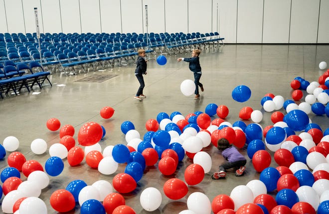 Brothers Berley Goodin, 11, left, and Brown, 8, play with balloons Saturday, July 13, 2024, after the Indiana Democratic State Convention in Indianapolis.