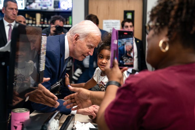 US President Joe Biden greets a young girl during a visit to Mario's Westside Market grocery store in Las Vegas, Nevada, on July 16, 2024.