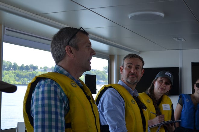 Lake Champlain Basin Program Communications and Publications Coordinator Ryan Mitchell speaks about the organizations recent State of the Lake report July 18, 2024. He stands next to UVM's Media Relations Director Basil Waugh and other media personnel.