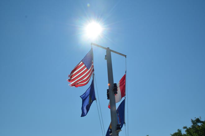 The sun shines high over the flags atop the Marcelle Melosira July 18, 2024.