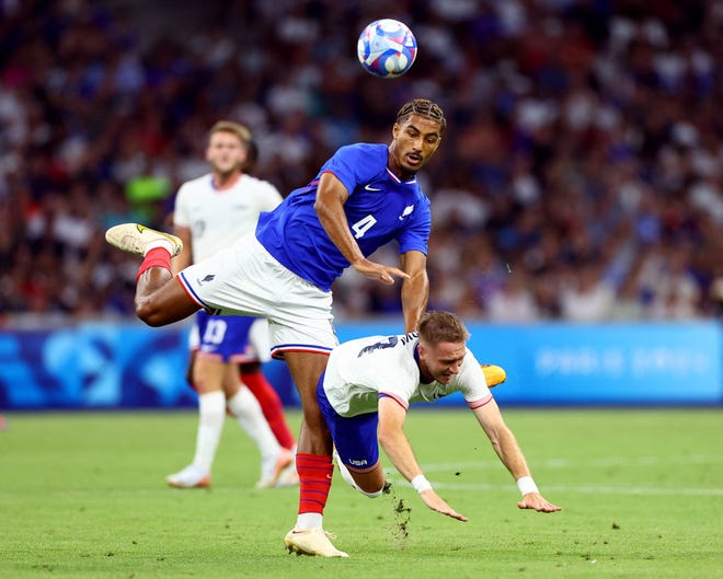 Loic Bade of France in action with Djordje Mihailovic of United States in action during a men's Group A football match on July 24, 2024, during the Paris 2024 Olympic Summer Games at Orange Velodrome in Marseille.