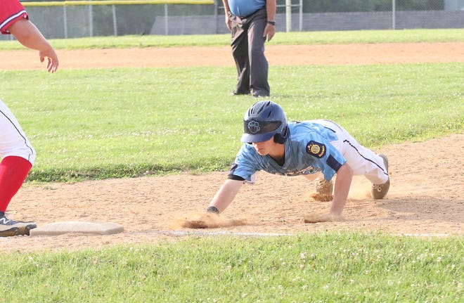 Cedric LaMothe dives back to 1st during the South Burlington Wildcats 3-2 win over St Johnsbury Post 58 on Tuesday night at Veterans Memorial Park in South Burlington.