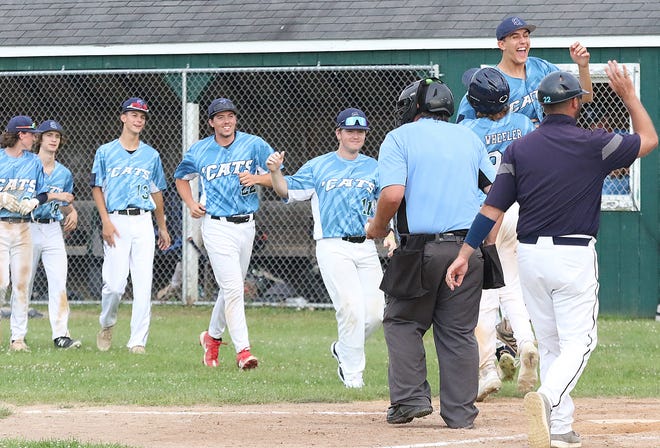 The South Burlington Wildcats celebrate after scoring the game winning run against St Johnsbury Post 58 in the bottom of the 7th inning on Tuesday night at Veterans Memorial Park in South Burlington.