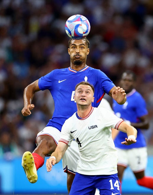 Loic Bade of France in action with Djordje Mihailovic of United States in action during a men's Group A football match during the Paris 2024 Olympic Summer Games at Orange Velodrome on July 24, 2024, in Marseille, France.