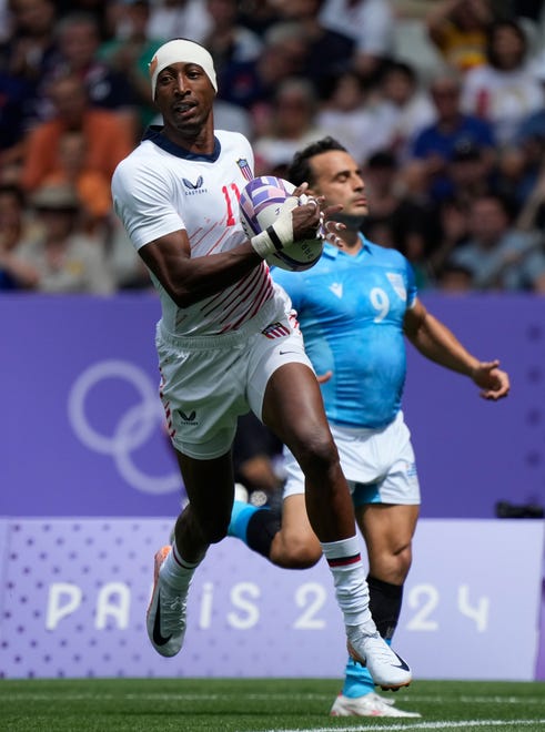 Team United States back Perry Baker (11) scores against Uruguay during the Paris 2024 Olympic Summer Games at Stade de France.