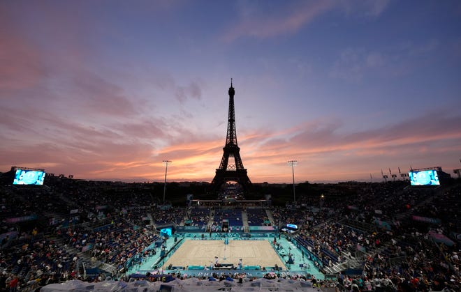 A general view of the Eiffel Tower as the sun sets before a beach volleyball preliminary phase match during the Paris 2024 Olympic Summer Games at Eiffel Tower Stadium.