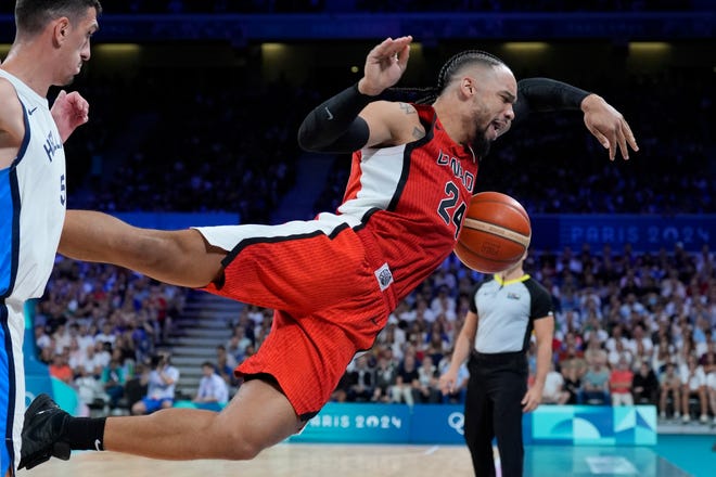 Canada small forward Dillon Brooks (24) tries to keep the ball in bounds against Greece guard Giannoulis Larentzakis (5) in the first half during the Paris 2024 Olympic Summer Games at Stade Pierre-Mauroy.