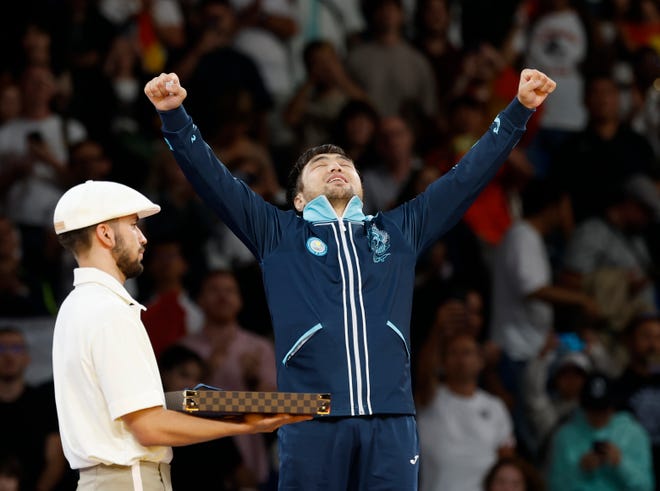 Yeldos Smetov (KAZ) celebrates his gold medal during the Paris 2024 Olympic Summer Games at Champ-de-Mars Arena.