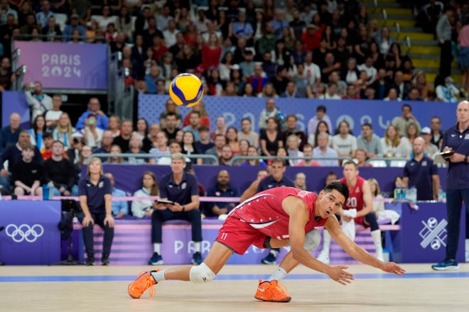 United States of America setter Micah Christenson (11) dives for the ball in the first against Argentina during the Paris 2024 Olympic Summer Games at South Paris Arena 1.