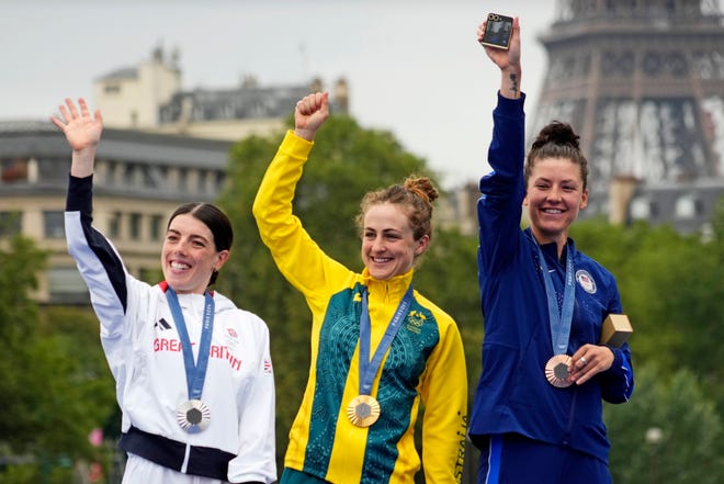 Anna Henderson (GBR) celebrates winning the silver medal, Grace Brown (AUS) celebrates winning the gold medal and Chloe Dygert (USA) celebrates winning the gold medal in the women’s individual time trial road cycling during the Paris 2024 Olympic Summer Games at Grand Palais-Pont Alexandre III.