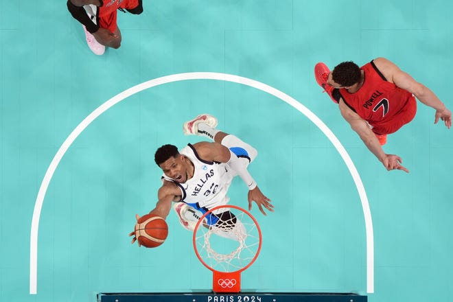 Greece small forward Giannis Antetokounmpo (34) shoots against Canada power forward Dwight Powell (7) in the second half during the Paris 2024 Olympic Summer Games at Stade Pierre-Mauroy.